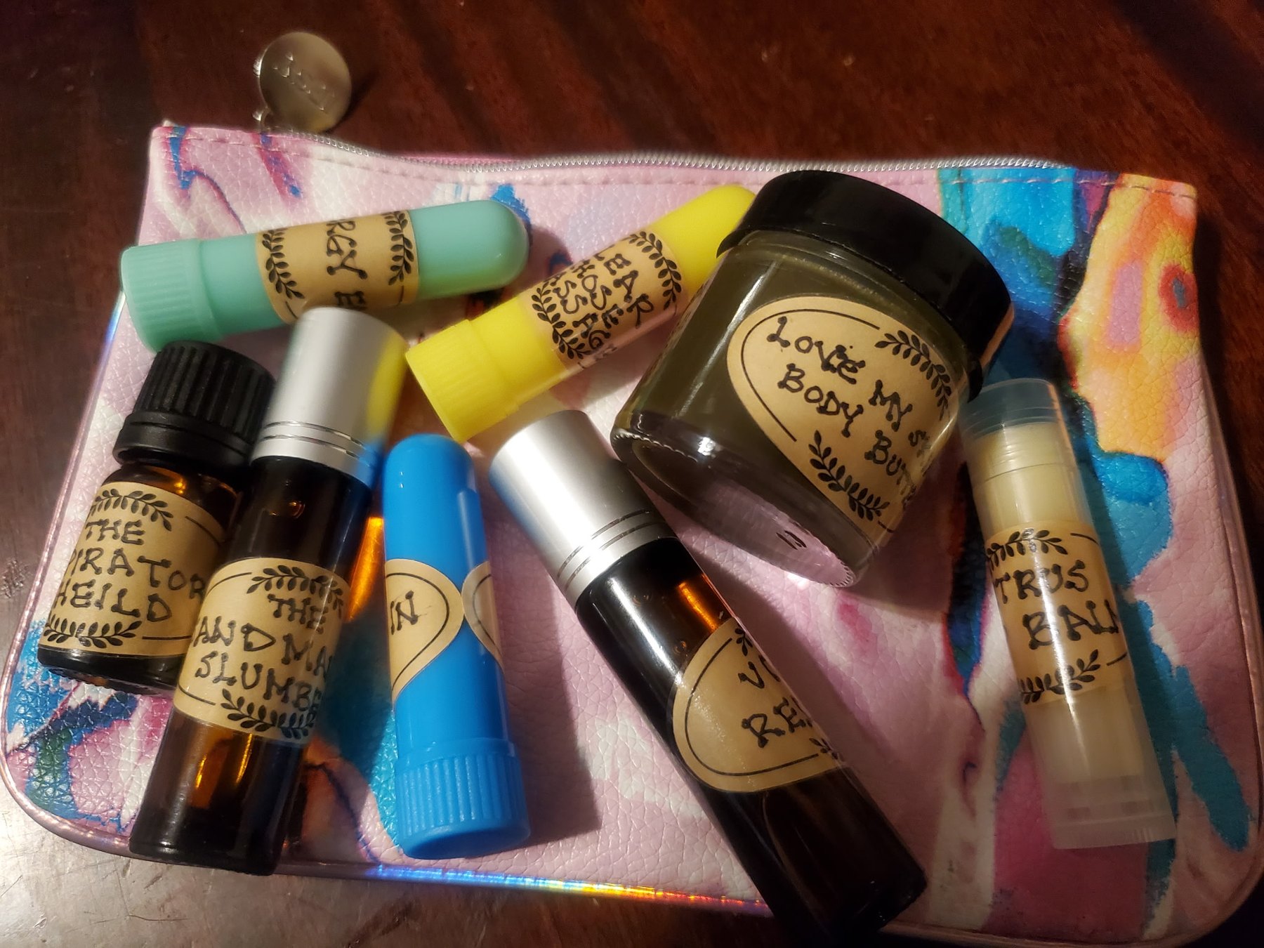 Handcrafted aromatherapy rollers, inhalers and balms in a pink pouch