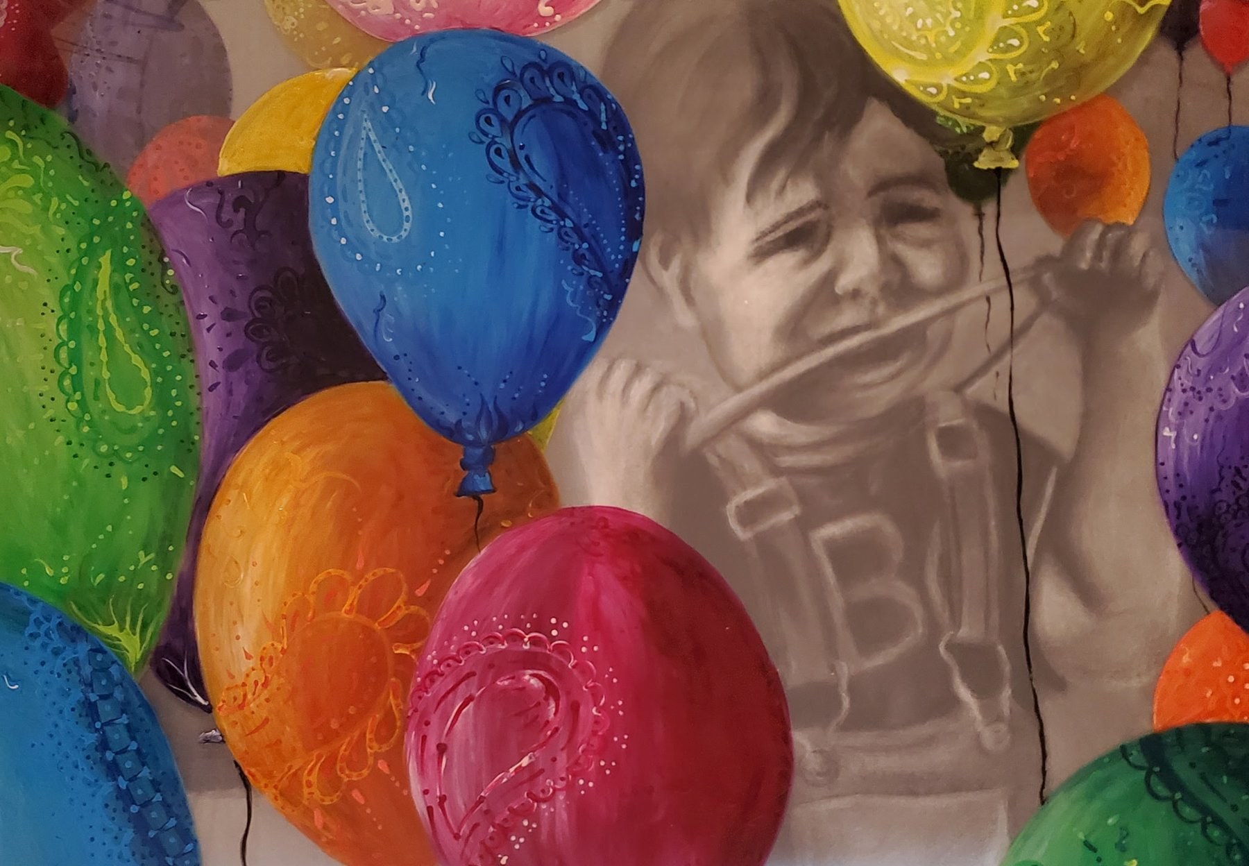 Painting of bright balloons over a grayscale child