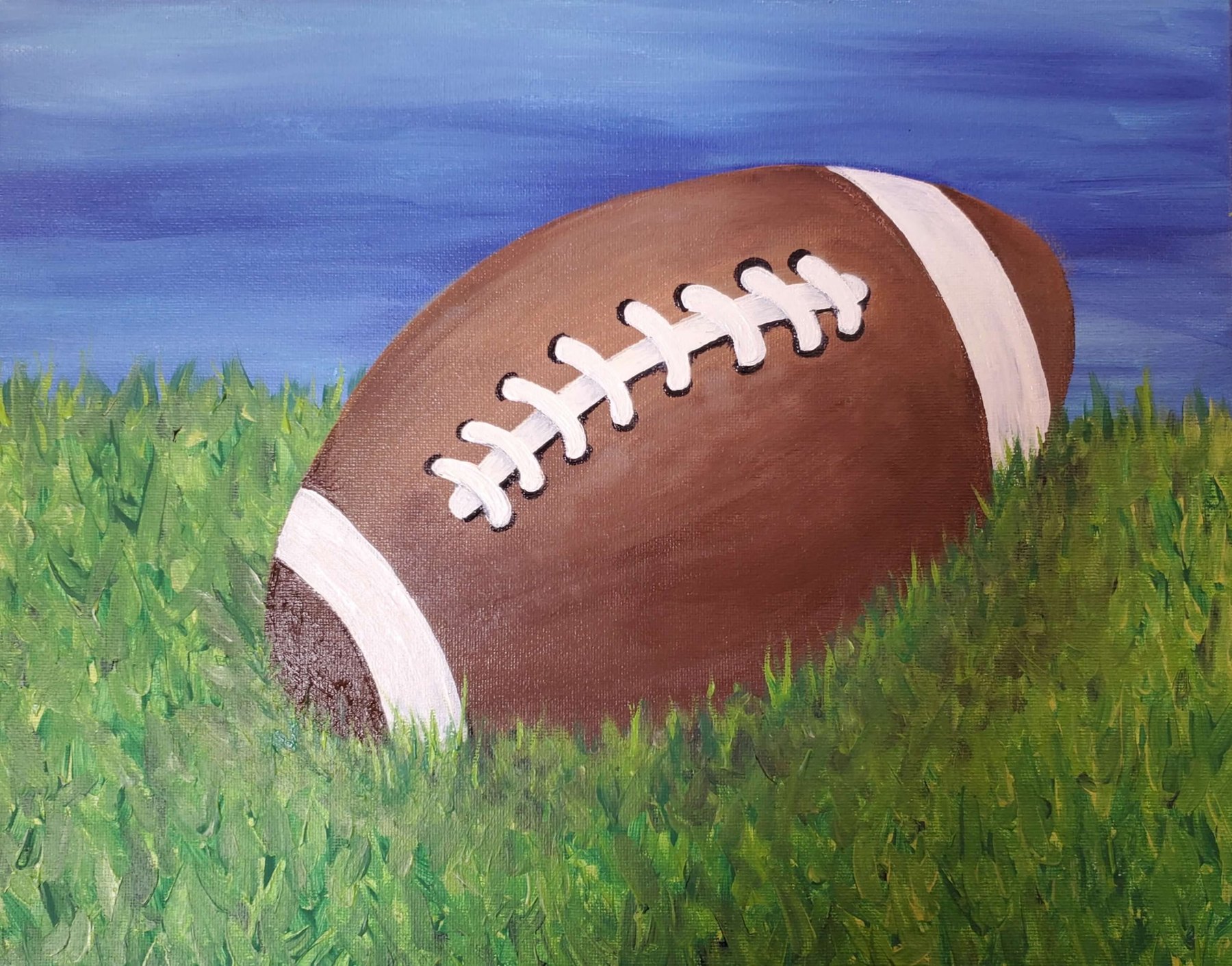 Acrylic painting of a football in the grass