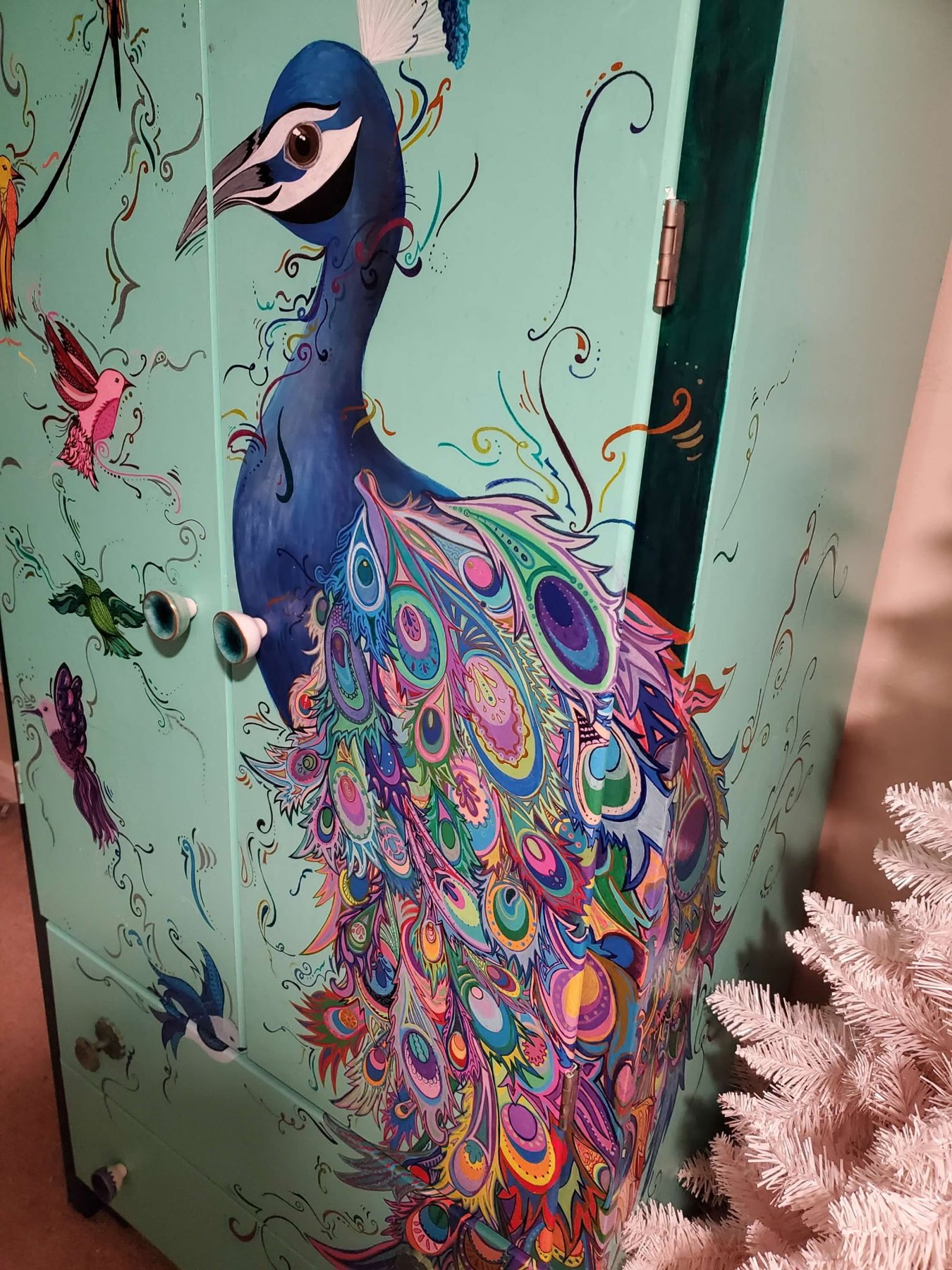 Upcycled armoire hand painted with a peacock